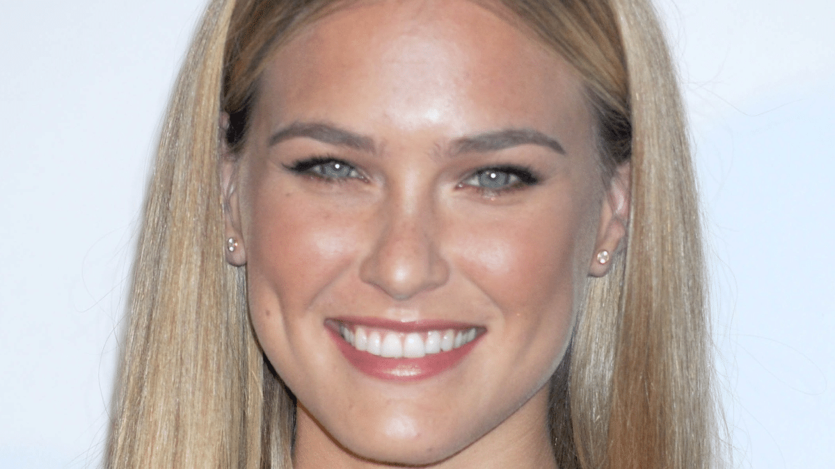 As the sun sets in the balcony, Bar Refaeli is all smiles in a bra and jeans