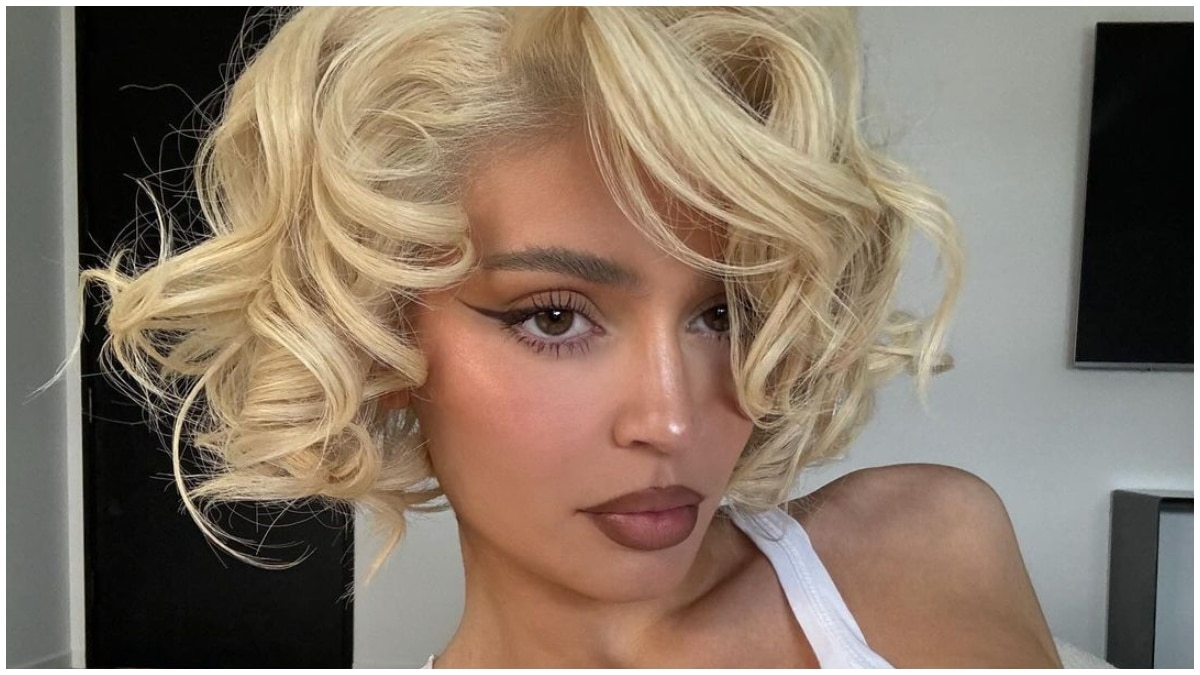 Kylie Jenner wearing a blonde wig and making a serious face for the camera.